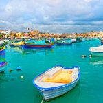 Luzzu boats in Marsaxlokk harbor of bay Mediterranean sea Malta